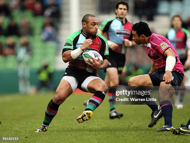 Jordan Turner-Hall of Harlequins is tackled by Casey Laulala of Cardiff Blues during the Heineken Cup round six match between Harlequins and Cardiff...