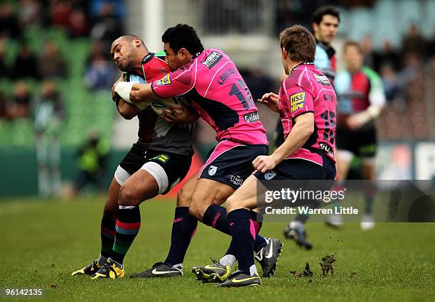 Jordan Turner-Hall of Harlequins is tackled by Casey Laulala of Cardiff Blues during the Heineken Cup round six match between Harlequins and Cardiff...