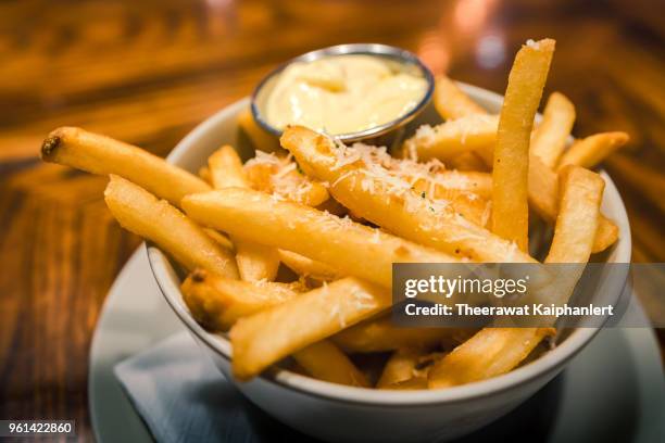 close-up bowl of french fries with mayonnaise dipping - cheesy fries stock pictures, royalty-free photos & images