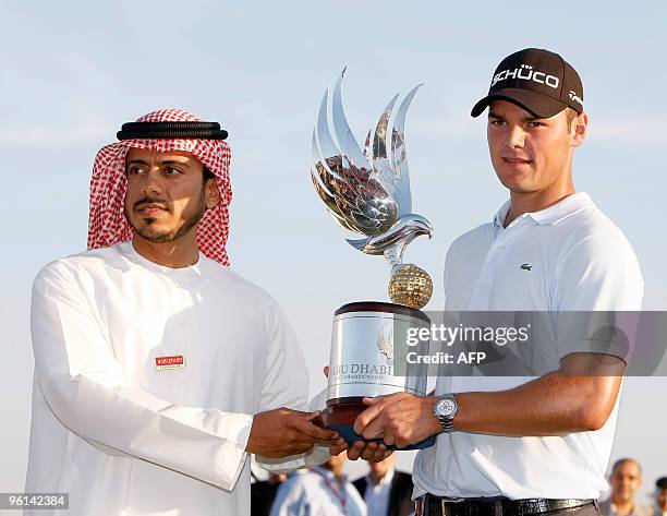 Martin Kaymer of Germany receives the trophy from Sheikh Sultan bin Tahnun al-Nahyan, the chairman Abu Dhabi's culture department, after winning on...