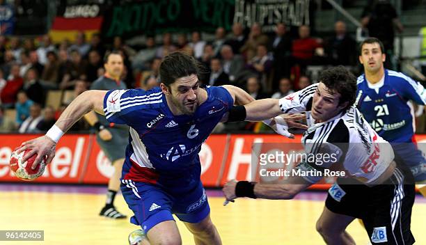 Torsten Jansen of Germany in action with Bertrand Gille of France during the Men's Handball European main round Group II match between Germany and...