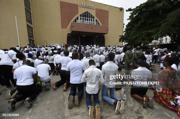 People kneel to pray for victims of violent attacks across the country at Ikeja St Leo Catholic Church, Ikeja in Lagos, on May 22, 2018. - Catholic...