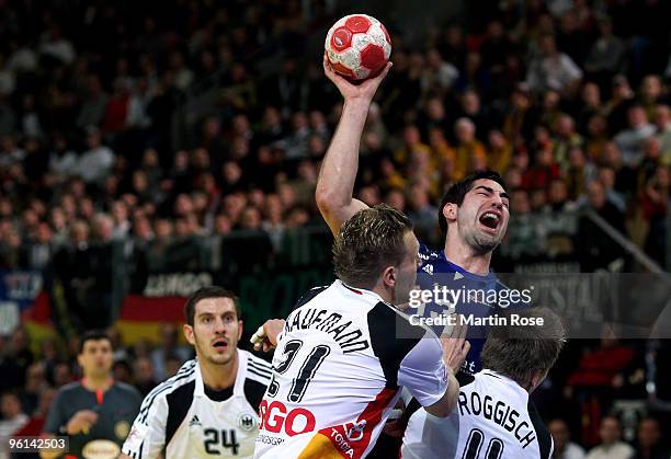 Oliver Roggisch of Germany in action with Nikola Karabatic of France during the Men's Handball European main round Group II match between Germany and...