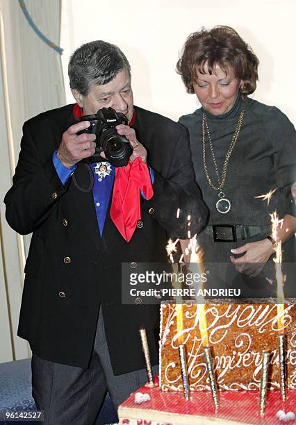 Actor Jerry Lewis , 80-year-old, flanked by his wife SanDee Pitnick , takes a picture of his birthday cake after being awarded the French Legion...