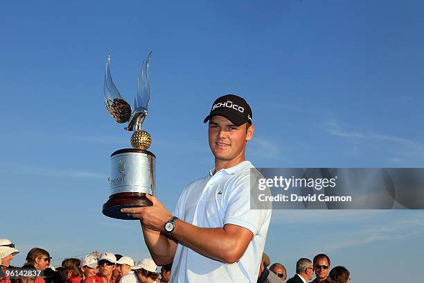 Martin Kaymer of Germany holds the trophy after the final round of The Abu Dhabi Golf Championship at Abu Dhabi Golf Club on January 24, 2010 in Abu...