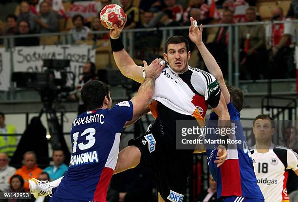 Michael Haass of Germany in action with Nikola Karabatic of France during the Men's Handball European main round Group II match between Germany and...
