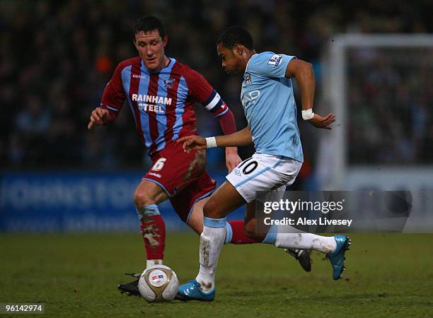 Robinho of Manchester City goes past Cliff Byrne of Scunthorpe United during the FA Cup sponsored by E.ON Fourth round match between Scunthorpe...