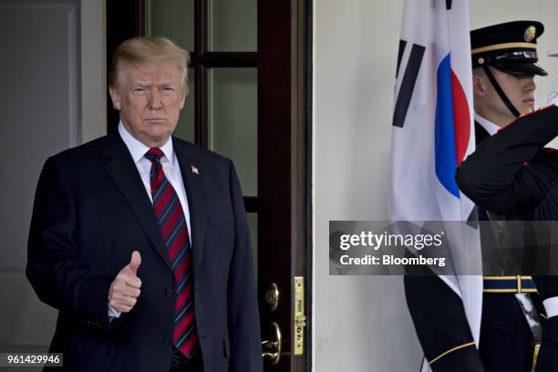 President Donald Trump gives a thumbs up while waiting to greet Moon Jae-in, South Korea's president, not pictured, at the West Wing of the White...