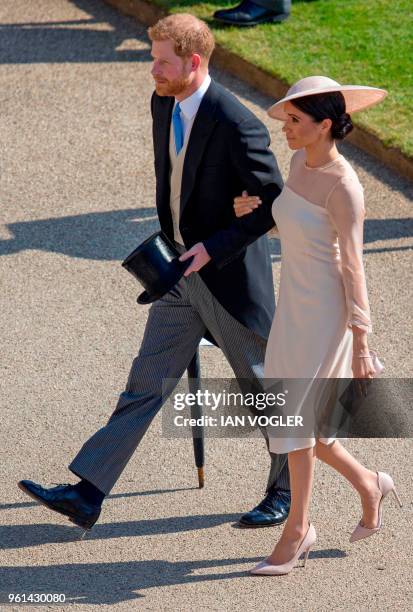 Britain's Prince Harry, Duke of Sussex and his new wife Britain's Meghan, Duchess of Sussex, attend the Prince of Wales's 70th Birthday Garden Party...