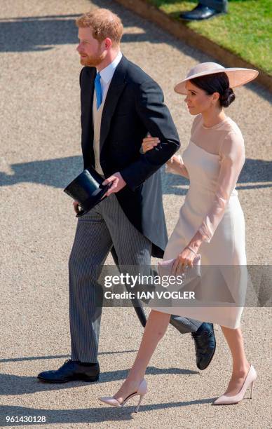 Britain's Prince Harry, Duke of Sussex and his new wife Britain's Meghan, Duchess of Sussex, attend the Prince of Wales's 70th Birthday Garden Party...