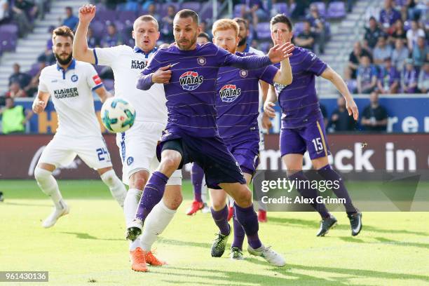 Christian Tiffert aa is challenged by Marvin Pourie of Karlsruhe during the 2. Bundesliga Playoff Leg 2 match between Erzgebirge Aue and Karlsruher...