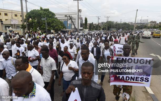 People march and carry banners to protest against violent attacks across the country in Lagos, on May 22, 2018. - Catholic churches in Nigeria held...