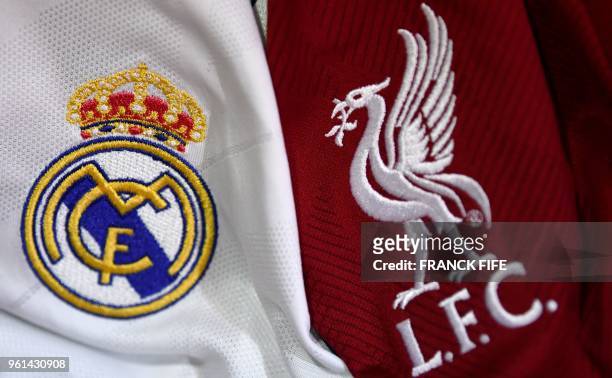 This picture taken on May 22, 2018 in Paris, shows the logos on jerseys of Real Madrid and Liverpool FC. - Real Madrid CF and Liverpool FC will play...