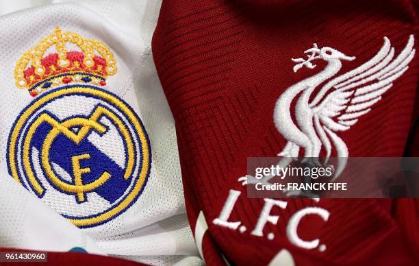 This picture taken on May 22, 2018 in Paris, shows the logos on jerseys of Real Madrid and Liverpool FC. - Real Madrid CF and Liverpool FC will play...