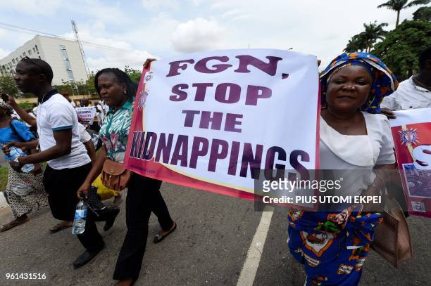 Women take part in a march to protest against victims of violent attacks across the country in Lagos, on May 22, 2018. - Catholic Churches in Nigeria...