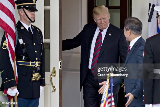 President Donald Trump, center, gestures for Moon Jae-in, South Korea's president, right, to enter the West Wing of the White House in Washington,...