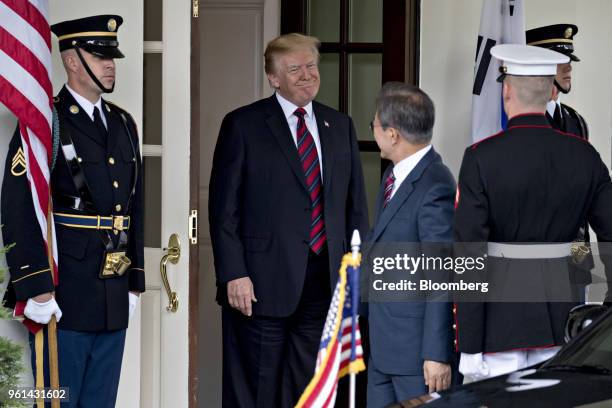 President Donald Trump, center, smiles while greeting Moon Jae-in, South Korea's president, center right, at the West Wing of the White House in...