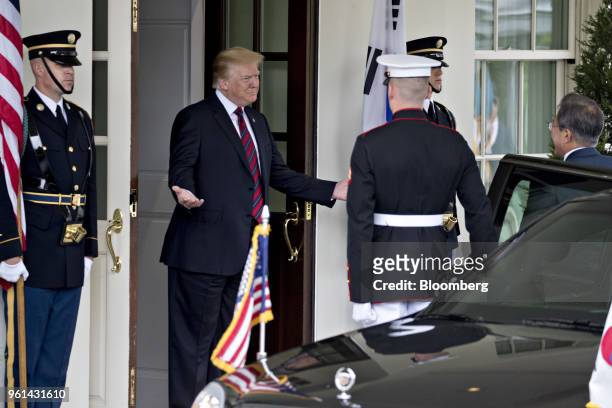 President Donald Trump, center, gestures while greeting Moon Jae-in, South Korea's president, right, at the West Wing of the White House in...