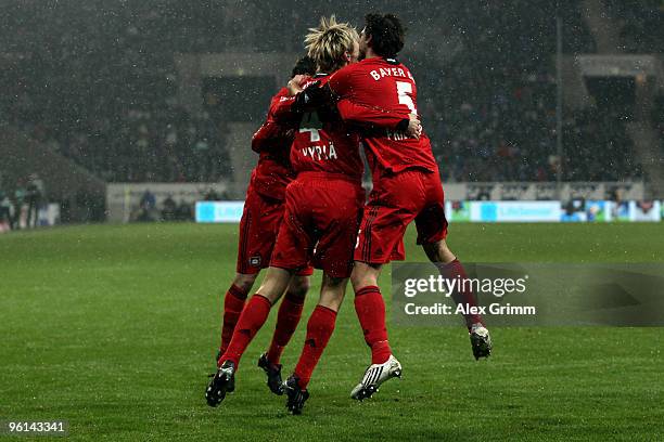 Sami Hyypiae of Leverkusen celebrates his team's first goal with team mates Manuel Friedrich and Tranquillo Barnetta during the Bundesliga match...