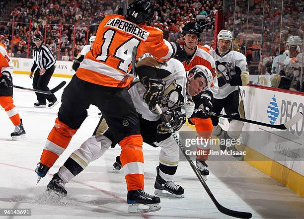 Sidney Crosby of the Pittsburgh Penguins is checked by Ian Laperriere of the Philadelphia Flyers on January 24, 2010 at Wachovia Center in...