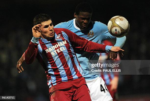 Scunthorpe United's Gary Hooper is challenged by Manchester City's Belgian defender Dedryck Boyata during their English FA Cup football match at...