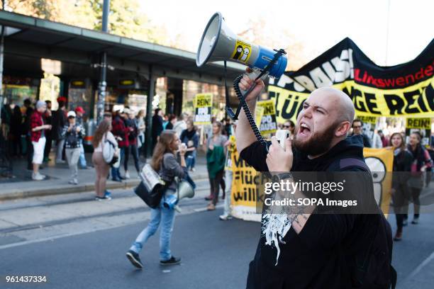 Man makes himself heard with a megaphone during a march in support of refugees fleeing Syria's civil war and other conflict zonesarriving in Austria...