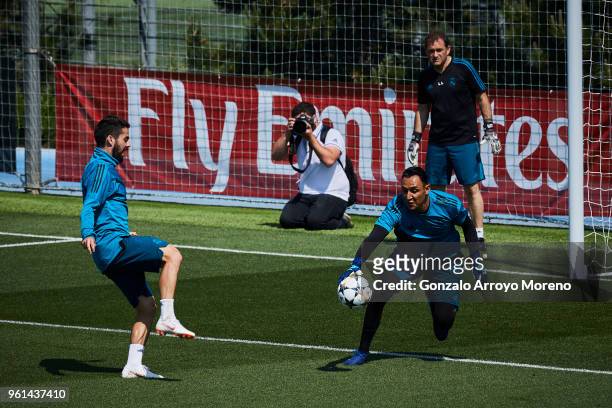 Goalkeeper Keylor Navas of Real Madrid CF stops the ball strikes by his teammate Francisco Roman Alarcon alias Isco during a training session held...