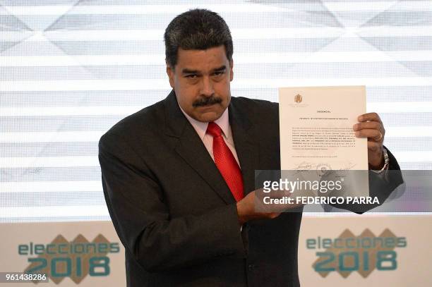 Venezuelan President Nicolas Maduro, shows the document issued by the National Electoral Council that proclaims him as re-elected President for the...