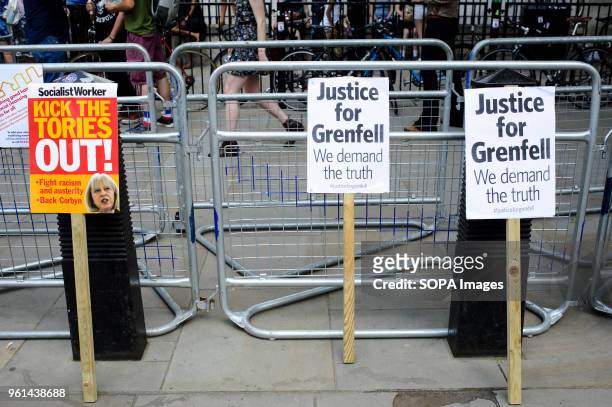 Placards calling for an end to Britain's Conservative government and for "Justice for Grenfell" lean against bollards and fencing at a demonstration...