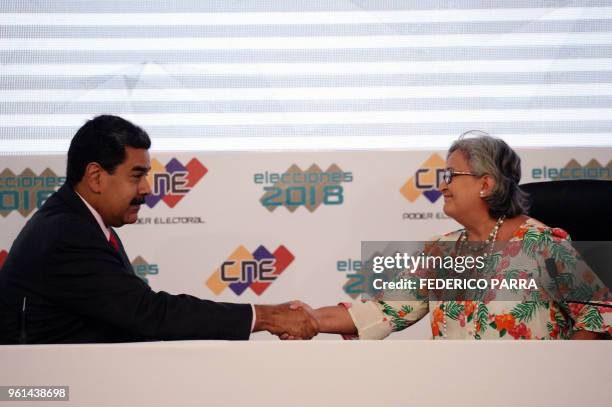 Venezuelan President Nicolas Maduro greets the president of the National Electoral Council Tibisay Lucena, during the ceremony of proclamation of his...