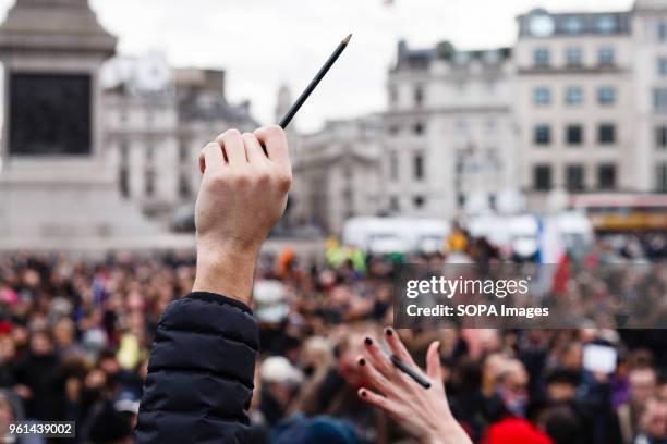 Demonstrators hold up pens and pencils at a solidarity and remembrance rally in Trafalgar Square called in response to a three-day string of terror...