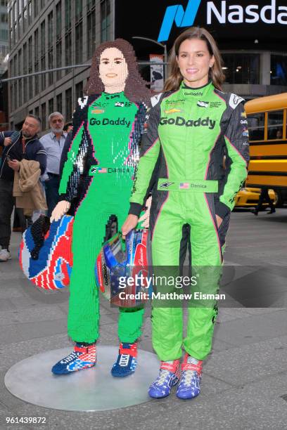Professional racing driver Danica Patrick poses for photos with a life-sized Lego statue of herself at NASDAQ MarketSite on May 22, 2018 in New York...