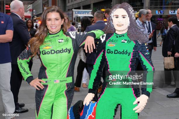 Professional racing driver Danica Patrick poses for photos with a life-sized Lego statue of herself at NASDAQ MarketSite on May 22, 2018 in New York...