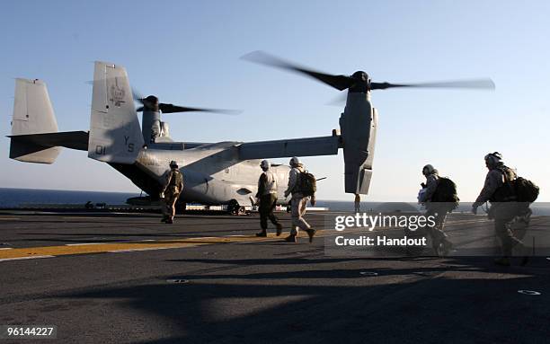 In this handout image provided by the U.S. Marine Corps, one of two MV-22 Ospreys tilt-rotor aircraft from Marine Medium Tilt Rotor Squadron 162 ,...