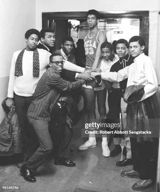 Boxing great Muhammad Ali, back row, second from left, poses with a group of young men, among them basketball great Kareem Abdul Jabbar, back row,...