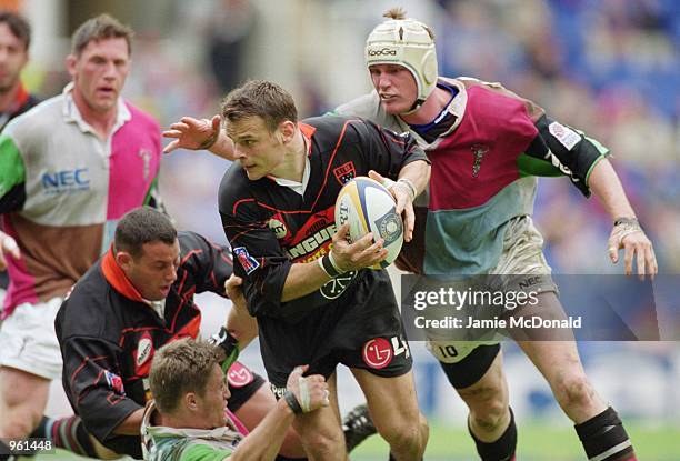 David Douy of Narbonne is tackled by Matt Perry and Steve White-Cooper of Harlequins during the European Shield Final between Harlequins and Narbonne...