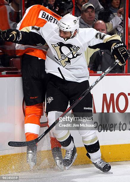 Craig Adams of the Pittsburgh Penguins checks Oskars Bartulis of the Philadelphia Flyers on January 24, 2010 at Wachovia Center in Philadelphia,...