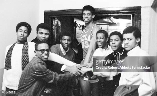 Boxing great Muhammad Ali, back row, second from left, poses with a group of young men, among them basketball great Kareem Abdul Jabbar, back row,...