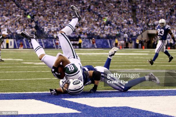 Tight end Dustin Keller of the New York Jets catches a nine-yard second quarter touchdown pass against Raheem Brock of the Indianapolis Colts during...