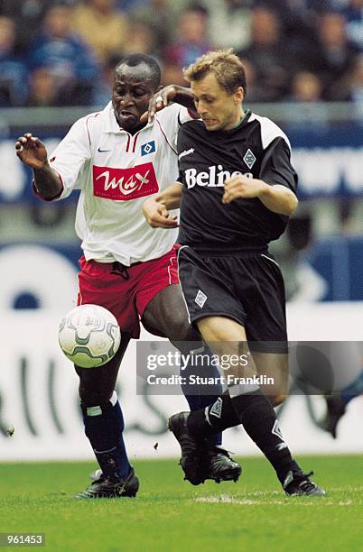 Tony Yeboah of Hamburg SV tussles with Peter Nielsen of Borussia Monchengladbach during the German Bundesliga match played at the Volksparkstadion,...