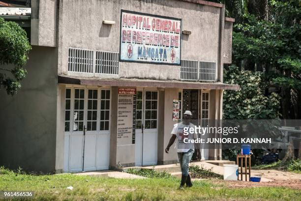 An International Red Cross Committee staff member walks in front of a quarantine zone at the hospital of Wangata in Mbandaka on May 22 in the...