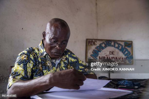 Sebastien Nseka Lokila, the administrator of the market studies papers at his office in Mbandaka on May 22 at the market where bush meat is sold in...