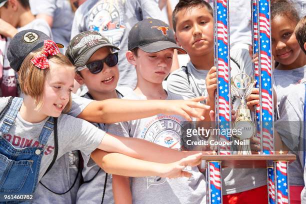 Students from Rayzor Elementary School celebrate after winning the co-school championship trophy during the first day of Speeding To Read at Texas...