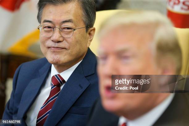 South Korean President Moon Jae-in listens as President Donald Trump speaks during a meeting in the Oval Office of the White House on May 22, 2018 in...