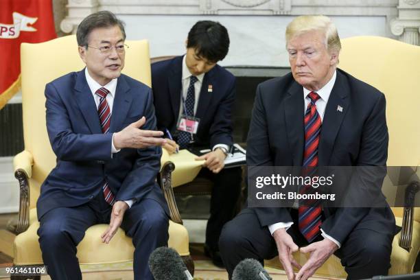 Moon Jae-in, South Korea's president, left, speaks as U.S. President Donald Trump listens during a meeting in the Oval Office of the White House in...