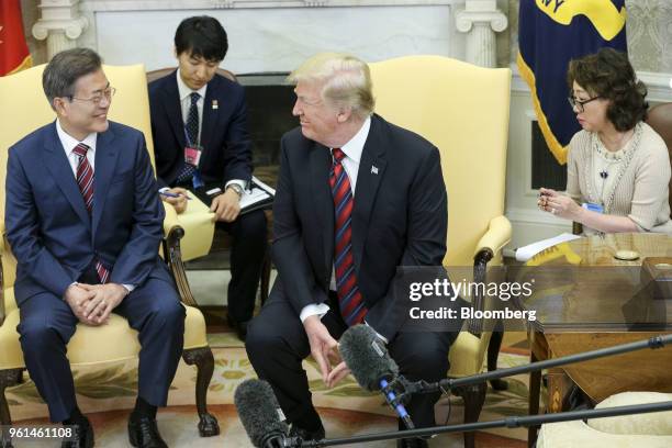 President Donald Trump, center, and Moon Jae-in, South Korea's president, left, smile during a meeting in the Oval Office of the White House in...
