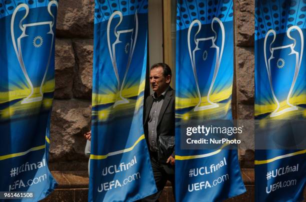 Man walks past the flags with the UEFA Champions League final logo in central in Kyiv, Ukraine, May 22, 2018