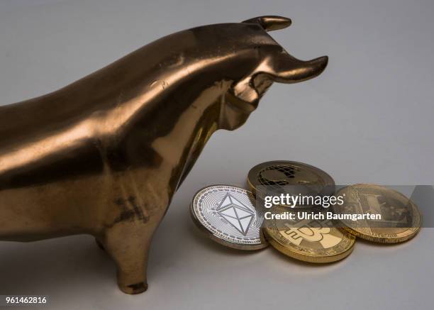 Symbol photo on the topics cryptocurrency, Ethereum, currency speculation, power consumption, etc. The picture shows a bull with Ethereum, Ripple,...