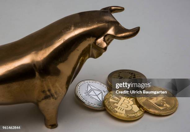 Symbol photo on the topics cryptocurrency, Ethereum, currency speculation, power consumption, etc. The picture shows a bull with Ethereum, Ripple,...