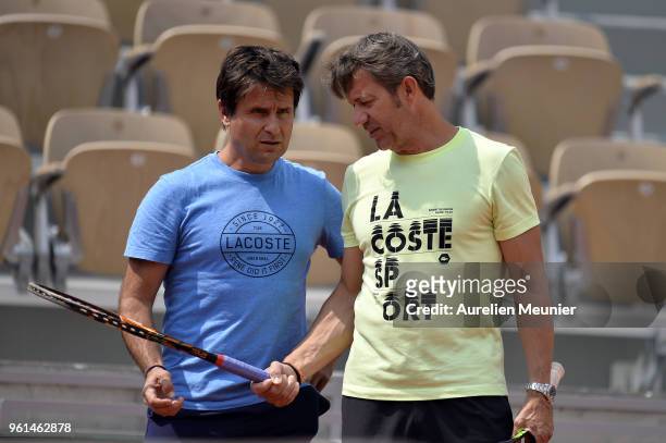 Richard Gasquet' s coache Fabrice Santoro and David Goffin's coach Thierry Van Cleemput speak during a practice session ahead of the French Open at...